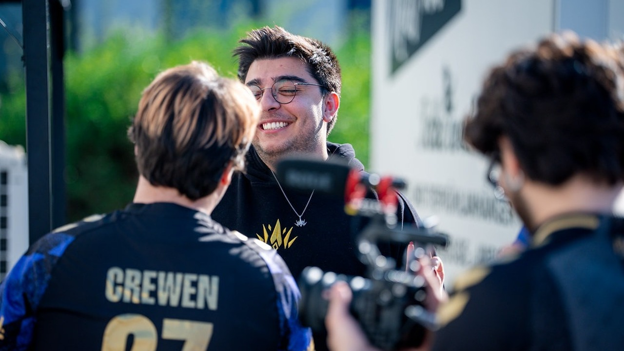 A PCIFIC Esports player smiles beside the stage cameras